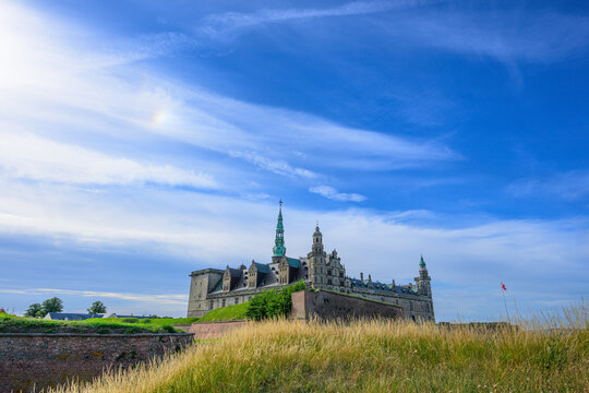 Helsing?r, Denmark - June 30 2026: Dramatic silhouette of Kronborg Castle behind tall coastal grass.