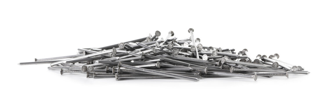 Many shiny metal nails isolated on white