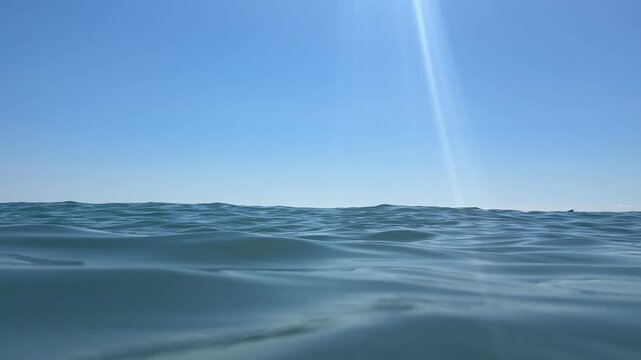 Soft ocean waves sparkling in sunlight. 4k