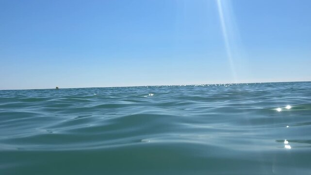 Soft ocean waves sparkling in sunlight. 4k