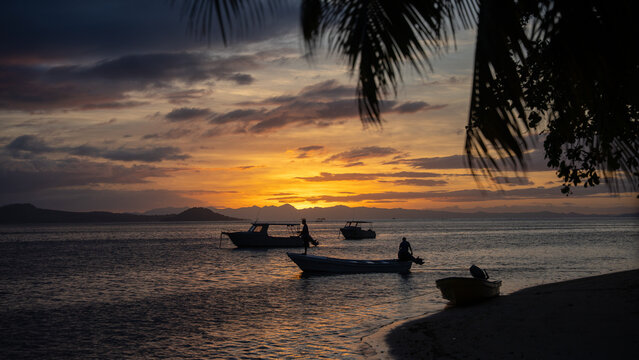 sunset on the beach with a boat