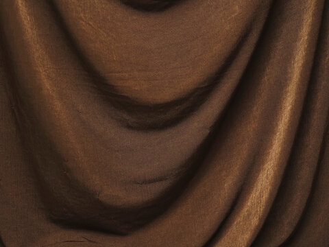 Colorful fabric with textured weave and soft folds. Luxurious velvet or silk surface catches light. Perfect for fashion, interior design, or luxury branding. Can be used in product shots, catalogs