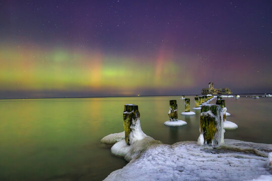 Baltic sea in Gdynia Babie Doly at winter night with northerm lights. Poland