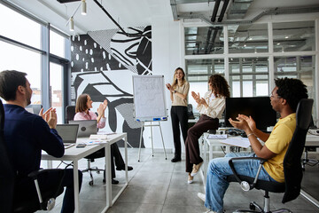 Fototapeta premium Diverse business team giving presentation during a collaborative office meeting