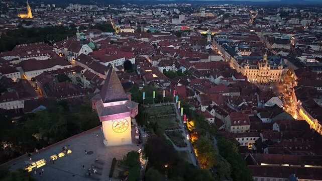 Aerial night view of Graz Uhrturm clock tower, Hauptplatz square and Rathaus town hall, Austria
