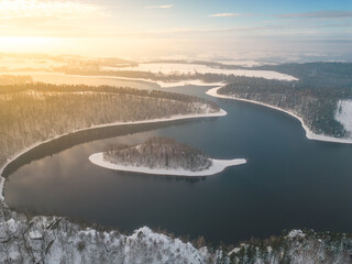 Obraz premium Sec water reservoir with small forested island in the middle. Iron Mountains, Czechia. Aerial view from drone.