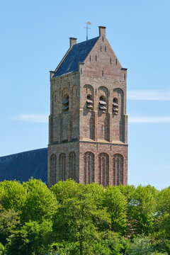 The tower of the 16th century reformed church of Ferwert or Ferwerd in the so called rich gothic style. Image taken in summer against a blue sky.