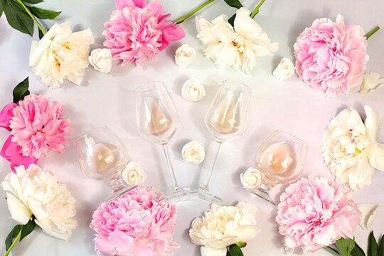 Still life with different types of rose wine, whiskey, summer alcoholic cocktail for a party and peonies on a light background, bar and cafe concept, advertising banner for an invitation