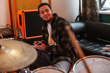 Obraz premium Young musician writing notes in a creative music studio