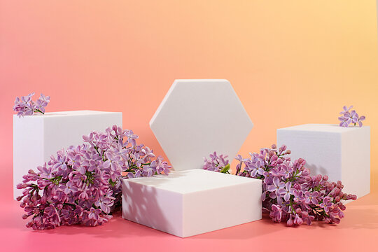 Empty product podium and fresh live spring flowers.Abstract beautiful flower arrangement with lilac blossoms,banner.Stage for business concept.Minimal modern aesthetics and elegant beauty concept