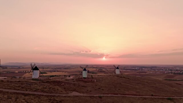 Don quixote windmills sunset over la mancha countryside