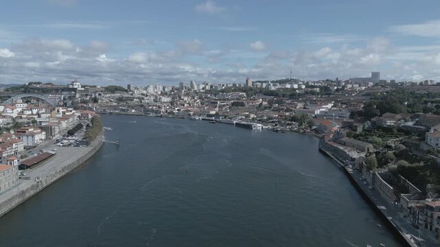Porto, Portugal cityscape with the Douro River and historic bridges, featuring the Infante Bridge and Maria Pia Bridge, surrounded by traditional Portuguese architecture and scenic urban landscape.
