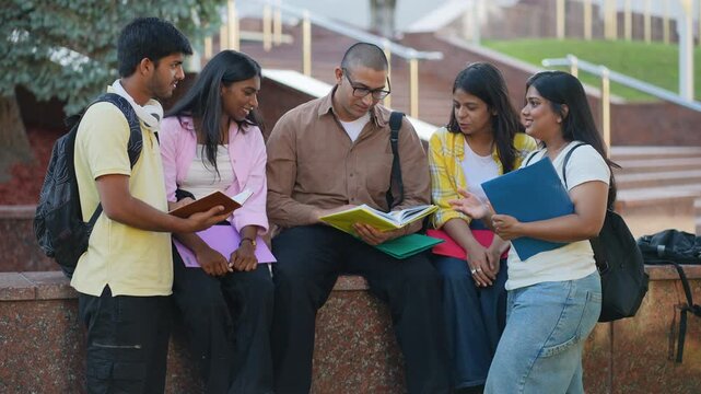 Group of indian students discussing homework on campus