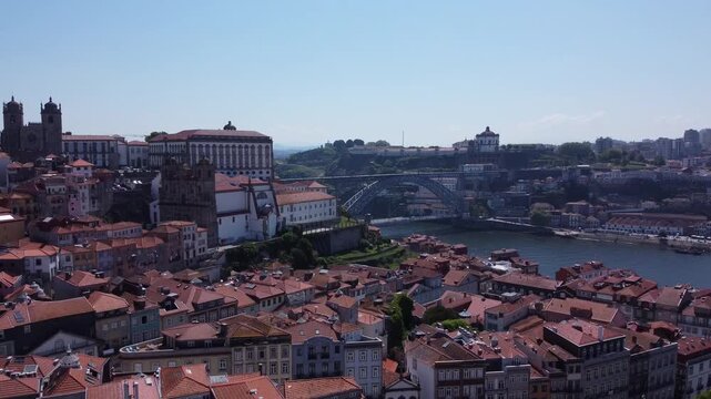 Porto, Portugal cityscape with the Douro River and historic bridges, featuring the Infante Bridge and Maria Pia Bridge, surrounded by traditional Portuguese architecture and scenic urban landscape.