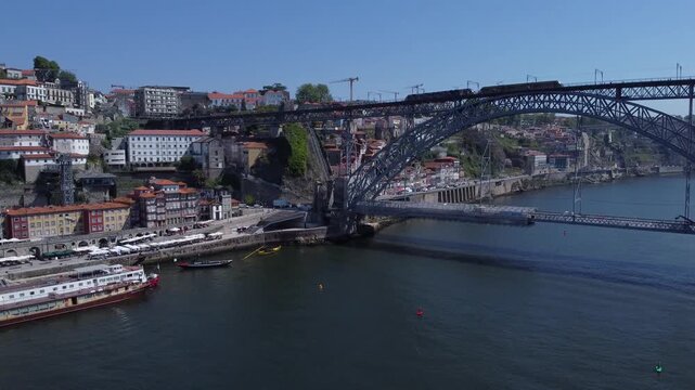 Porto, Portugal cityscape with the Douro River and historic bridges, featuring the Infante Bridge and Maria Pia Bridge, surrounded by traditional Portuguese architecture and scenic urban landscape.