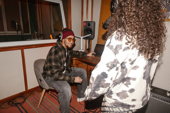 Two young musicians making music in a creative music studio