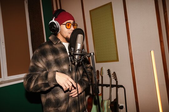 Young musician singing song in a creative music studio