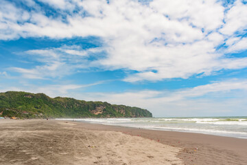 Parangtritis tropical beach with blue sky and clouds