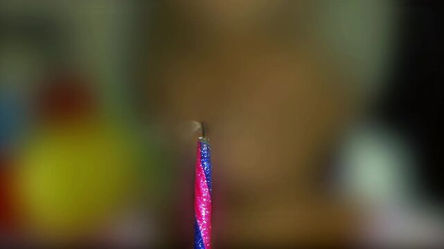 Close Up of Elderly Woman Blowing Out Birthday Candle with Blurred Face - 4K
