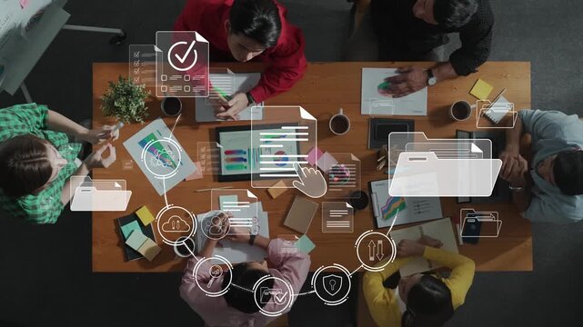 A diverse group of professionals collaborates in a modern office setting, utilizing digital tools and data visualization to enhance productivity and foster creativity. Raster