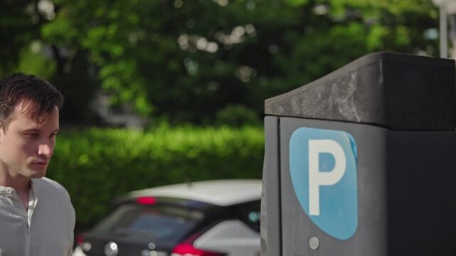 Man Examining Parking Meter with Blue P Symbol