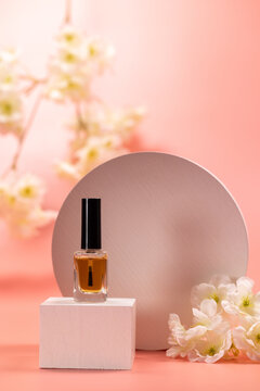 Nail polish bottle standing on podium with flowers