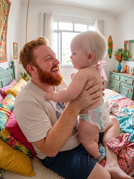 Father holding laughing baby