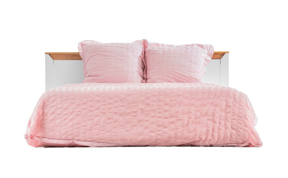 Pink ruffled bedding set with two pillows and a textured duvet on a modern bed frame, isolated, the soft fabric and cozy design create a comfortable and inviting atmosphere for sleep and relaxation