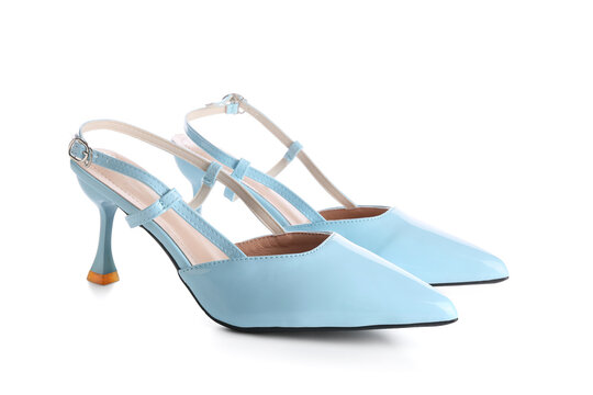 Pair of light blue patent leather slingback high heels with pointed toes and ankle straps, isolated on a white background