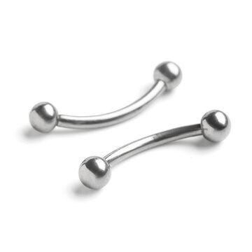 Two shiny curved barbells, body piercing jewelry made of stainless steel, isolated on a clean white background
