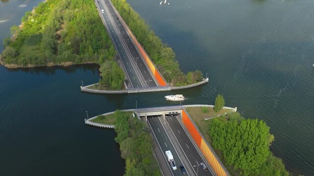 Aerial view of the veluwemeer aqueduct, a unique water bridge in the netherlands where boats sail over a highway with traffic