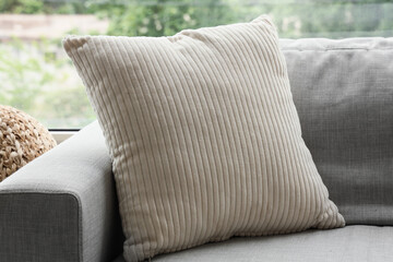 Beige corduroy throw pillow on a gray sofa, home decor and comfortable living room interior design, the textured cushion adds a soft element to the home interior design © Pixel-Shot