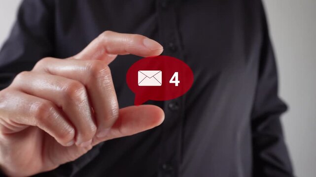 A hand holds a red speech bubble icon. The red icon indicates the number of unread messages. Useful for communication and messaging.