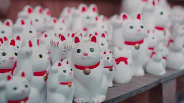 Hundreds of traditional white Maneki Neko lucky cat statues at Gotokuji Temple, one of Tokyo's most unique and culturally significant attractions.
