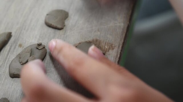 Decorating handmade pottery with clay ornaments and reliefs