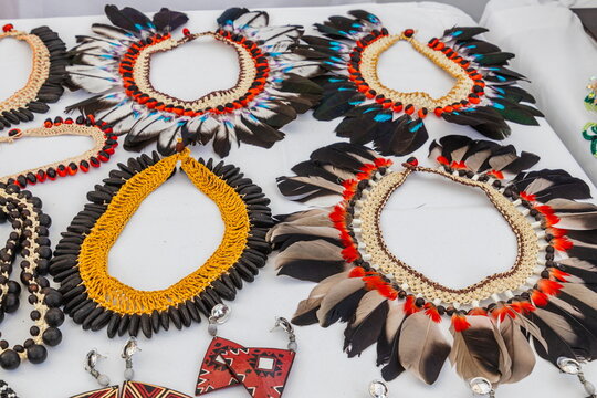 Traditional ceremonial and everyday necklaces, handmade from vibrant bird feathers and native Amazonian plant seeds, made by indigenous communities (Kichwa, Waorani, Shuar) in Ecuador.