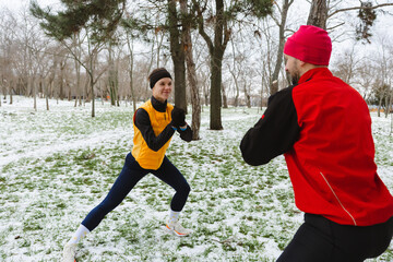 Fototapeta premium Two active friends fighting snow during an active winter day