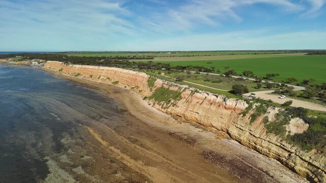 Port Julia, Yorke Peninsula, South Australia &ndash; 4K aerial drone view of red limestone cliffs, old coast road, surrounding farmland, and Gulf St Vincent.
