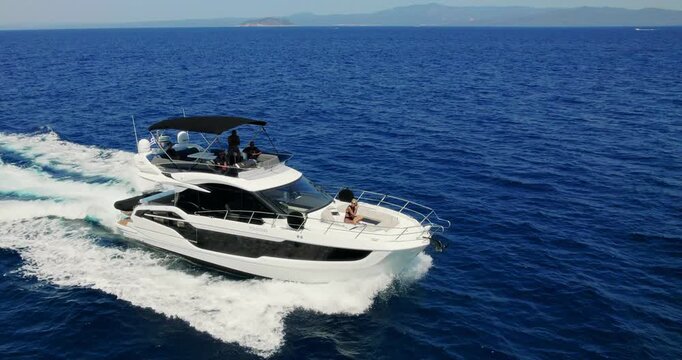 Luxury Motor Yacht Cruising in Blue Greek Sea Aerial View