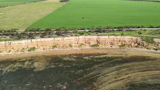 Port Julia, Yorke Peninsula, South Australia &ndash; 4K aerial drone view of red limestone cliffs, old coast road, surrounding farmland, and Gulf St Vincent.