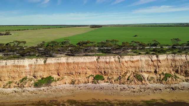 Port Julia, Yorke Peninsula, South Australia &ndash; 4K aerial drone view of red limestone cliffs, old coast road, surrounding farmland, and Gulf St Vincent.