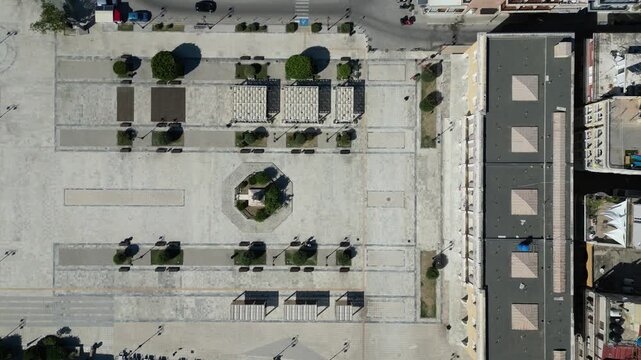 Aerial view of Solomos Square with geometric paving patterns and surrounding urban buildings in Zakinthos, Greece.