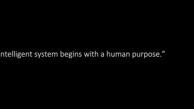Text on a solid black background displays an inspirational quotation stating that every intelligent system begins with a human purpose.