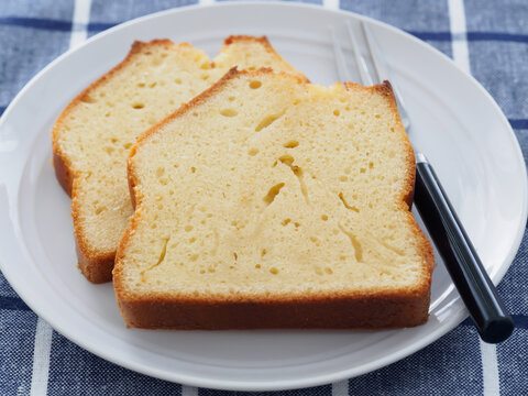 Two Slices of Pound Cake on White Plate with Blue Checkered Cloth