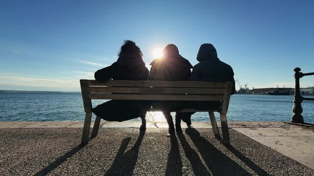 People Sitting on Bench at Sunset by Sea in Thessaloniki Greece