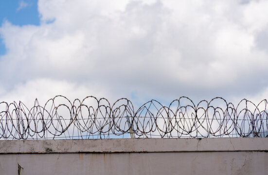 Prison Barbed Wire with cloud sky background