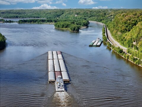 Barge headed North up the Mississippi River with the Upper Mississippi River Wildlife and Fish Refuge in the distance