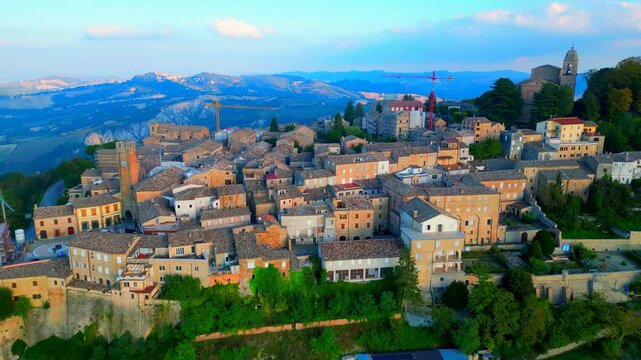 SANTA VITTORIA IN MATENANO, ITALY - OCTOBER 10, 2025: Aerial pullback shot of the town centre. Visitors can wander through a maze of well-preserved, quiet cobblestone streets with traditional bricks