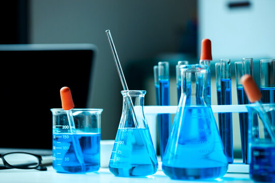 Blue Chemical Solutions in Laboratory Beakers and Flasks for Scientific Research, Chemistry Experiments, Pharmaceutical Testing and Biotechnology