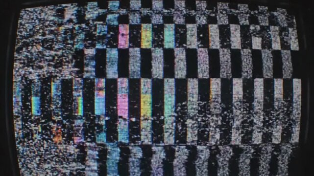 Close-up of a vintage television screen displaying colorful static and signal interference with distorted patterns.